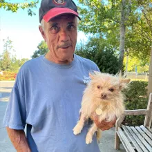 Man holding small dog