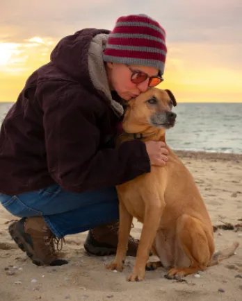 Hugging Dog on Beach