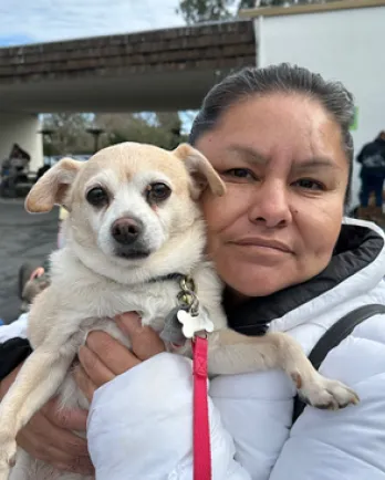 White dog held by person