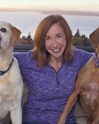 brown haired woman with two dogs