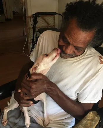 senior man holding senior dog