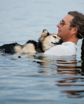 John Unger and Schoep, the dog, relaxing in water