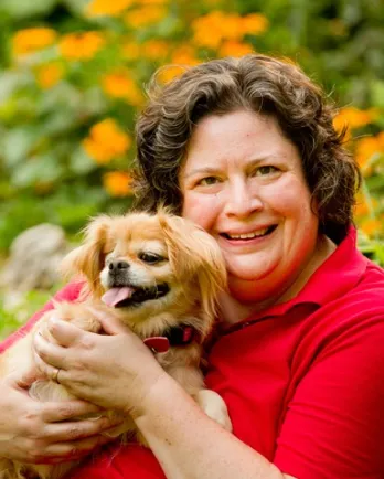 Julie Dudley holding her little dog