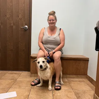 dog and person sitting on bench